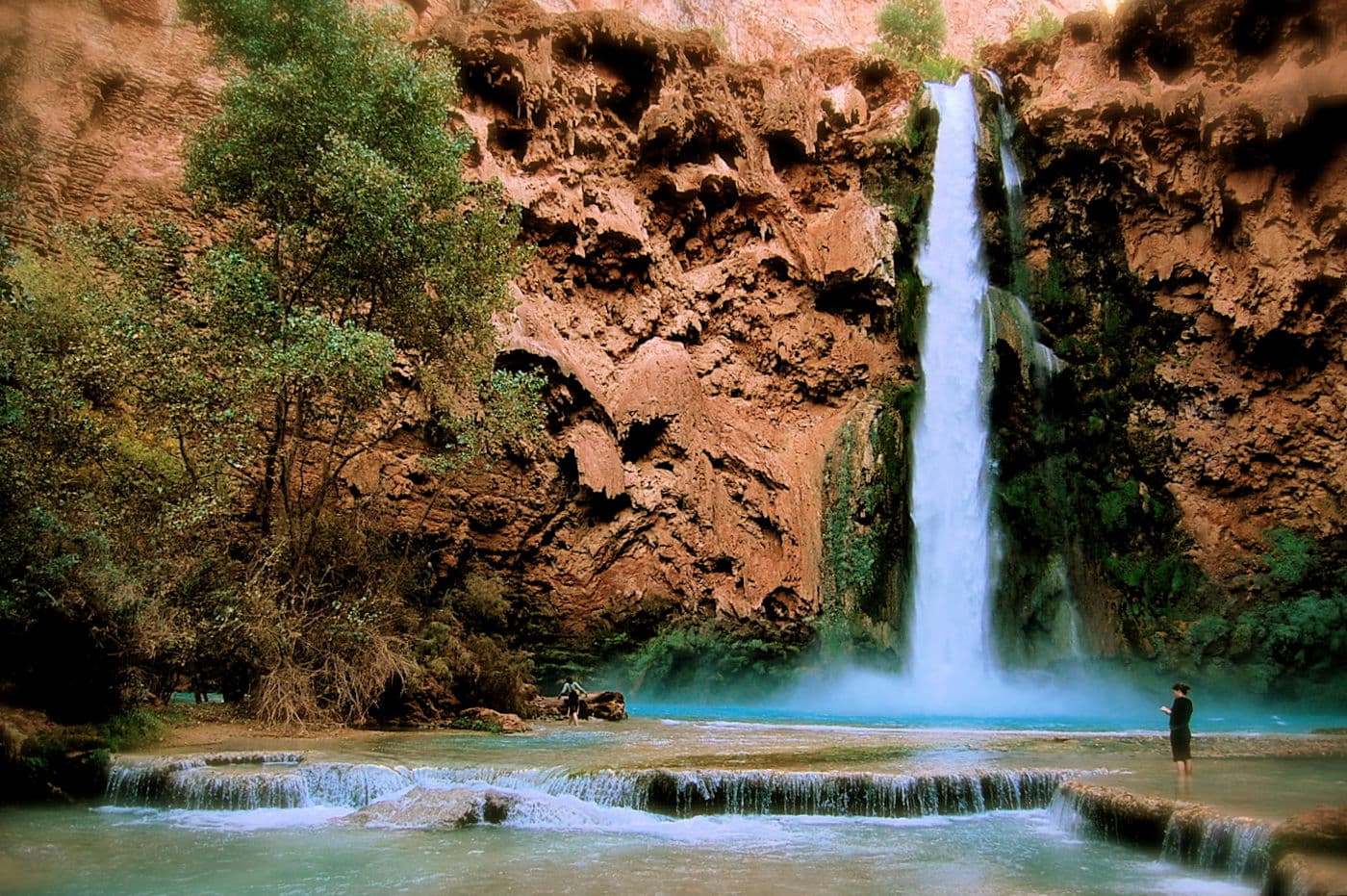 One of my favorite waterfalls. Mooney Fall in Havasu Canyon. I just love the turquoise waters flowing over shelves. I love that i caught a person in the shot enjoying the fall
